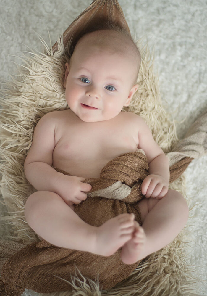 Infant On Palm Tree Pod