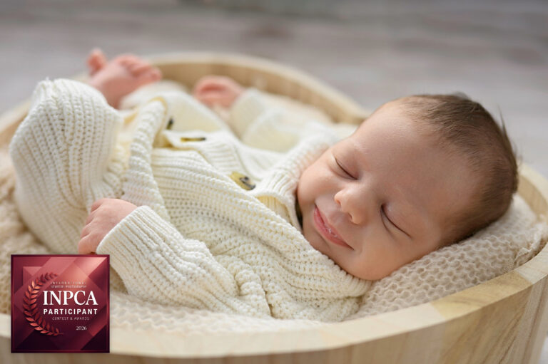 newborn girl smiling in her sleep